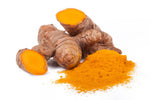 Tumeric root and powder on a white background